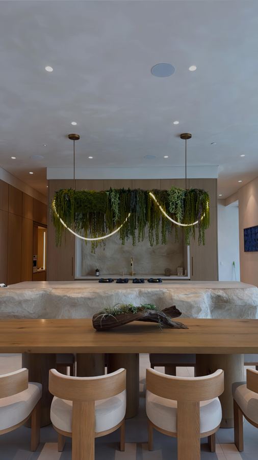 Kitchen with stone island and suspended greenery